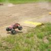 heading down the back stretch jump, the modified truck's advantage over a stuck truck is shown here. The Txt-2 with upgraded motors and and tires would be a competitive pice however.